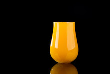 Glass Of Orange Juice Or Hazy New England IPA On Black Background