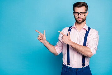 Sticker - Photo of handsome business man trend clothes guy eyesight vision specs hold arms direct fingers side empty space wear pink shirt suspenders pants isolated pastel blue color background