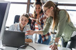 © BalanceFormCreative - Group of team workers and programmers starting a new project.Senior programmer giving help to beginner.
