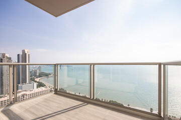 The glass balcony overlooks the sea.