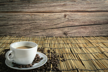 hot coffee cups with coffee beans bamboo background. Copy space.