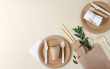 Plastic Free And Zero Waste Concept. Disposable Paper Tableware (cups, Plates, Wooden Forks, Knives, Spoons And Bamboo Straws) On Beige Background Top View