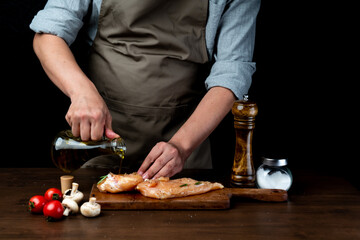 Wall Mural - The cook poured oil on the chicken breast