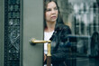 © Marina - Young woman going out of vintage building.