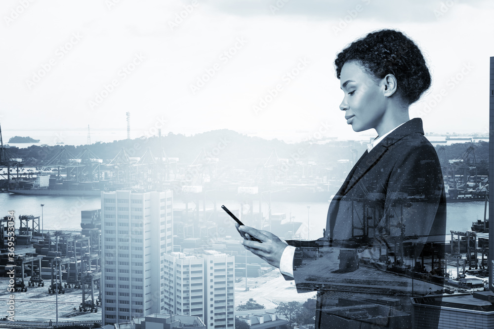 Attractive black African American business woman in suit using smart ...