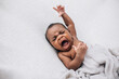 © Ursula Page - Crying and upset beautiful African American baby boy on a cream background