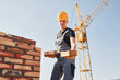 © standret - Holds bricks in hands. Construction worker in uniform and safety equipment have job on building