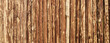 Wooden surface for natural background. Fence made of tree trunks.