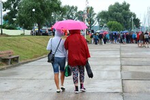 Women Walking Under An Umbrella