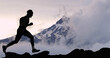 Running man athlete trail running in mountain summit background. Male runner on run training outdoors living active fit lifestyle. Silhouette at sunset.