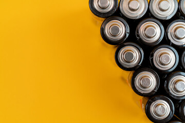 Poster - Top view of used batteries isolated on a yellow background