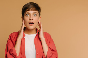  close-up portrait of a surprised girl. beige background in a photo studio