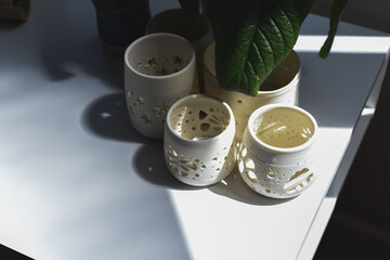 Group of hand made pottery vases and ceramic decorative bowls in room interior