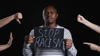 Wall Mural - People bullying African-American man on dark background. Stop racism