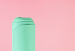 Rolled yoga gym mat isolated against a pink background, health and fitness concept with copy space