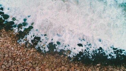 Wall Mural - Sea waves hitting rocks on the shore, aerial drone view