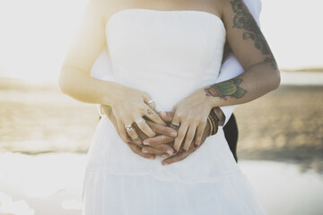 Poster - Closeup shot of a groom hugging his bride from behind