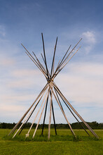 Traditional Native American Teepee Tent Wood Frame In The Grassy Alberta Plains In Early Evening