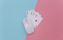 Online Casino. Pc Mouse And Four Aces On Pink Blue Background. Top View