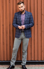 Wall Mural - Man in gray jeans and a jacket posing
