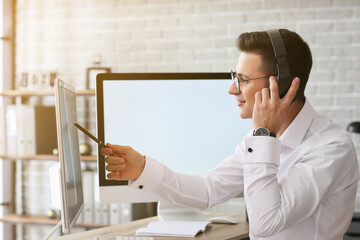 Poster - Man with headphones and computer working in office