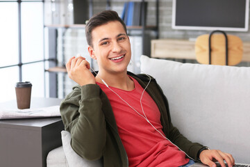 Poster - Man with earphones and laptop working in office