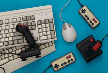 Wall Mural - Old keyboard, joysticks, gamepads and pc mouse on blue background. Retro gaming. 80s. Top view. Flat lay