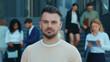 © Fractal Pictures - Caucasian handsome business man look at camera outside office building on break. Corporate manager, business person. Portraits.