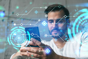 A man in casual wears, using smart phone. Double exposure. Tech theme hologram.