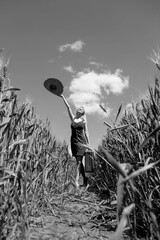 Sticker - Beautiful blonde girl with suitcase in wheat field in sunny day.