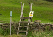 © Moorland Roamer - Bull in field  warning sign attached to a ladder stile over a drystone wall leading to  a public footpath. Aimed at hikers, walkers, and members of the public of the danger a bull may present