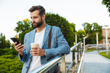 Wall Mural - Confident young man holding coffee cup