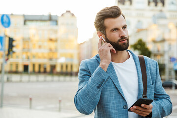 Wall Mural - Confident young business man walking outdoors