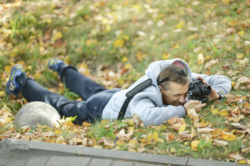 Sticker - Young guy taking pictures at autumn park