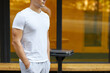 © kiy_lg - Close-up young man standing in the street with his hands in his pockets.