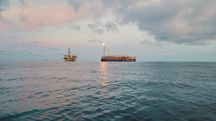 Wall Mural - FPSO tanker vessel near Oil Rig platform. Offshore oil and gas industry. Flare is burning with smoke. Environmental pollution