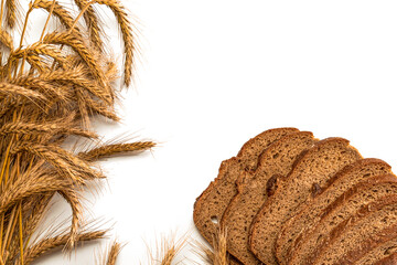 Rye bread isolated. Bakery with crusty loaves and crumbs. Fresh loaf of rustic traditional bread with wheat grain ear or spike plant on white background. Bio ingredients, very healthy with seeds.