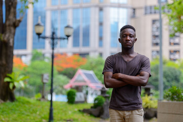 Wall Mural - Young African man at the park outdoors