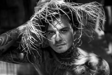 .young handsome man in a straw hat. Close-up portrait. Tropical island life.