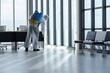 © kamonrat - Cleaning and Disinfection at office amid the coronavirus epidemic Professional teams for disinfection efforts Infection prevention and control of epidemic Protective suit and mask.