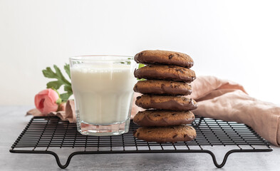 Oatmeal chocolate cookies with a glass of milk in the morning. Sweet treats concept 