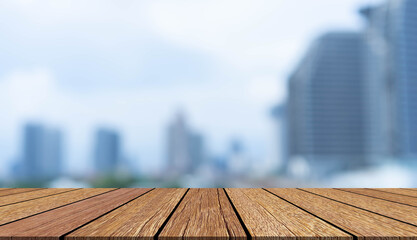 Wall Mural - Blurred blue building city background with wood panels perspective for show promote product concept