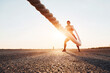 © standret - Woman in sportswear training with knots on the road at evening time