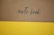 © Diana Kozii - a paper new notebook on a yellow background