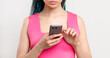 © golubovy - Millennial generation lifestyle. Woman in pink with blue colored hair braids using smartphone isolated on white. Mobile chat. Online communication. Digital technology. Social media.