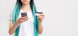 © golubovy - Millennial generation woman with blue hair braids. Confident lady with creative hairstyle paying with credit card on phone unrecognizable isolated on white copy space. Mobile banking. Online shopping.