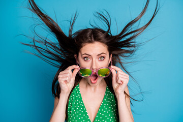 Sticker - Close up photo of astonished girl touch hand specs impressed news information novelty wind blow air hairstyle wear good look clothes isolated over blue color background