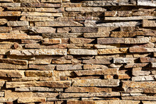 Background Of Stone Wall Texture. The Surface Of The Stones Is Brown