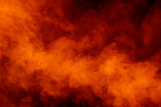Fototapete - Orange smoke on black background