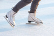 Legs of a skater on ice skating on the street ice rink. winter sport. hobbies and active recreation in sports.